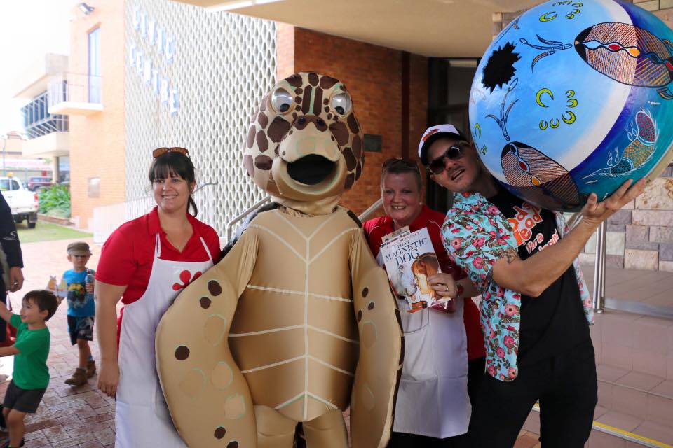 Turtle mascot with support crew